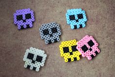 four perler beads are laying on the floor next to each other