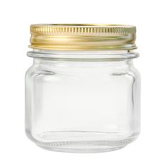 an empty glass jar with a gold lid