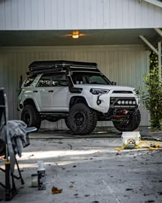 a white truck parked in front of a garage