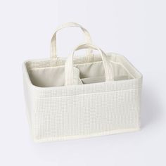 a white basket with two compartments and handles