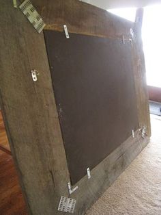 an old wooden frame with some tape on it