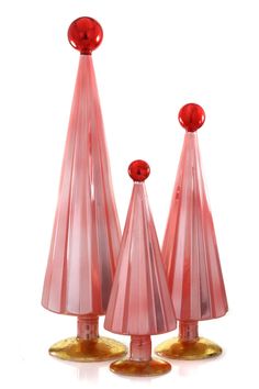 three pink glass candlesticks on top of each other