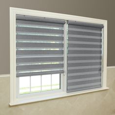 the blinds in this bathroom are made from gray and white striped fabric, while the window is closed