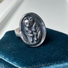 This is the first of my series called Cat Naps. I hand carved and sculpted this kitty ring in wax and cast it in Sterling Silver here in my shop. I tried to get as much detail as possible into the carving including tiny toe beans. It has patina and a brushed finish with polished highlights. I love that I can carry this adorable sleepy cat with me wherever I go.  The ring is form fitting to the finger and the band tapers from 5mm wide down to 3mm at bottom. The top measures 18mm x 22mm. It weighs a substantial 13.5 grams of Sterling Silver. It is currently a size 6.5 but can be resized to a variety of sizes. Please choose your size when placing your order and feel free to message me with any questions or if your size is not listed. Toe Beans, Cat Ring, Sleepy Cat, Cat Nap, Rings Statement, Statement Rings, Carry On, Patina, Hand Carved