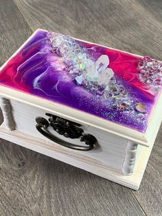 an open box with purple and pink designs on it