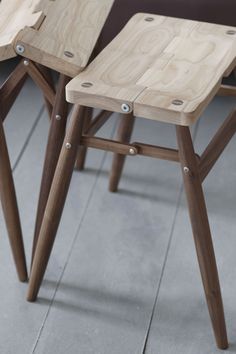 three wooden stools sitting next to each other