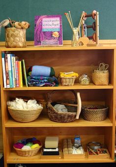 a book shelf filled with books and baskets