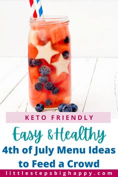 a mason jar filled with blueberries, strawberries and other fruit on top of a white table