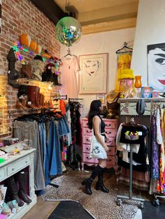 a woman is looking at clothes in a store