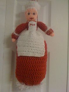 a crocheted doll hanging on the front door