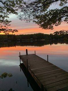 a wooden dock sitting in the middle of a lake