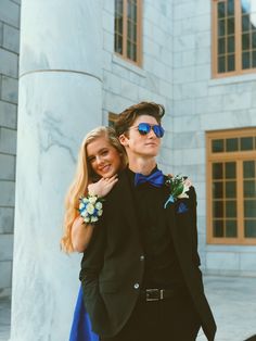 a young man and woman dressed in formal wear