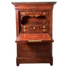 an old wooden desk with drawers on it