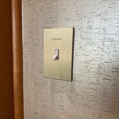 a light switch mounted to the side of a wall with white and silver paint on it