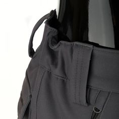 the back pocket of a black jacket on a mannequin