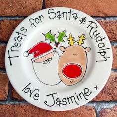 a white plate with santa and rudolph on it that says, let's for santa