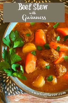 beef stew in a bowl with carrots and parsley on the side for garnish