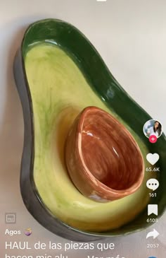 an avocado shaped bowl sitting on top of a table