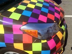 a multicolored car parked in a parking lot