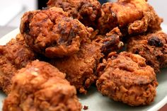 some fried food is on a white plate and ready to be eaten by someone else