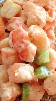 a close up of food on a plate with bread and vegetables in the background to make it look like they are eating something