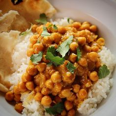 a white plate topped with rice and chickpeas