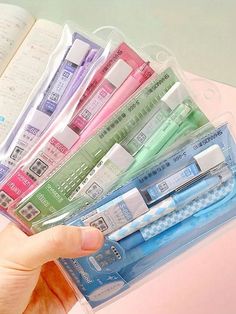 a person holding a plastic case with different types of toothbrushes in it