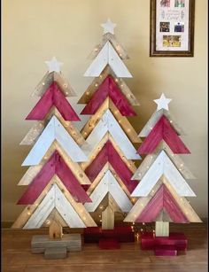 a christmas tree made out of wooden planks with white and pink stripes on it