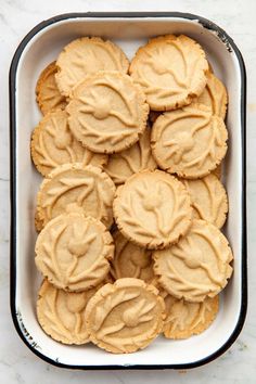 peanut butter cookies in a baking dish on a marble countertop with the top frosted