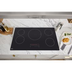 an electric cooktop on a marble counter top