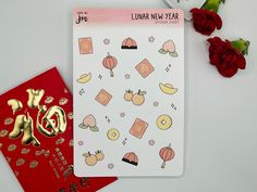 two chinese new year's cards next to red roses