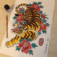 a tiger with flowers on it's chest and an ink brush next to it