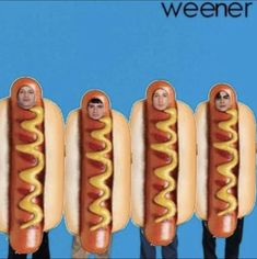 four hotdogs with people's faces on them in the shape of buns