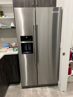 a large stainless steel refrigerator in a kitchen