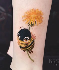 a small tattoo of a bee and a flower