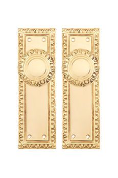 two golden door handles on a white background