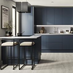 a kitchen with blue cabinets and stools