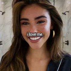 a woman smiling with the words i love me in front of her face and behind her ear