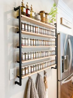 a kitchen wall shelf filled with jars and spices