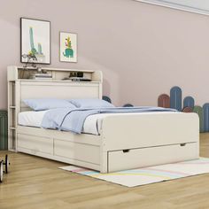 a white bed sitting on top of a hard wood floor next to a pink wall