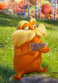 the lorax is sitting on top of a rock and holding a book in his hand