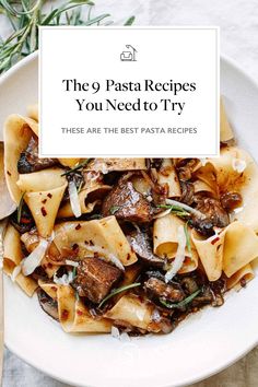 pasta with meat and cheese in a white bowl next to a fork on a table