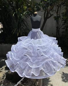 a mannequin is dressed in a white dress with ruffles on the skirt