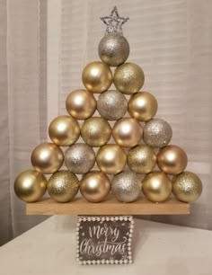 a christmas tree made out of gold and silver balls