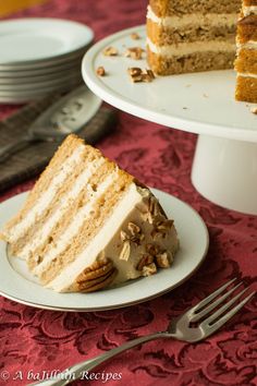 a slice of cake on a plate with a fork next to the rest of the cake