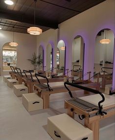 a row of wooden benches sitting next to each other on top of a white floor