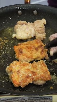 someone is frying chicken in a pan on the stove