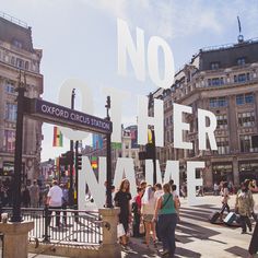 people are walking around in the city with no other name sign