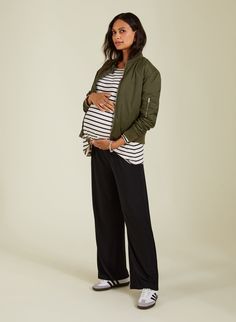 Description Modelled by 35 weeks pregnant Nicole The most comfortable and versatile maternity trousers - ever! We love the Eda because the wide-leg shape looks good with both trainers and heels. Made from stretchy and eco-conscious jersey, not only does the under-the-bump elasticated waistband offer all-day comfort throughout pregnancy, but they come in handy afterwards too. Enjoy wearing on repeat! "Comfort & style, you won't want to take them off!" - Natalie, Head of Design Crafted in soft and Business Casual Pregnancy Outfits, Pregnant Winter Outfits, Maternity Wear Bump Friendly Black Bottoms, Maternity Sweatpants, Chic Pregnancy Style, Casual Black Maternity Bottoms, Maternity Work Pants, Stretch Black Maternity Pants, Moon Outfits