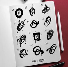 an open notebook with black and white symbols on it